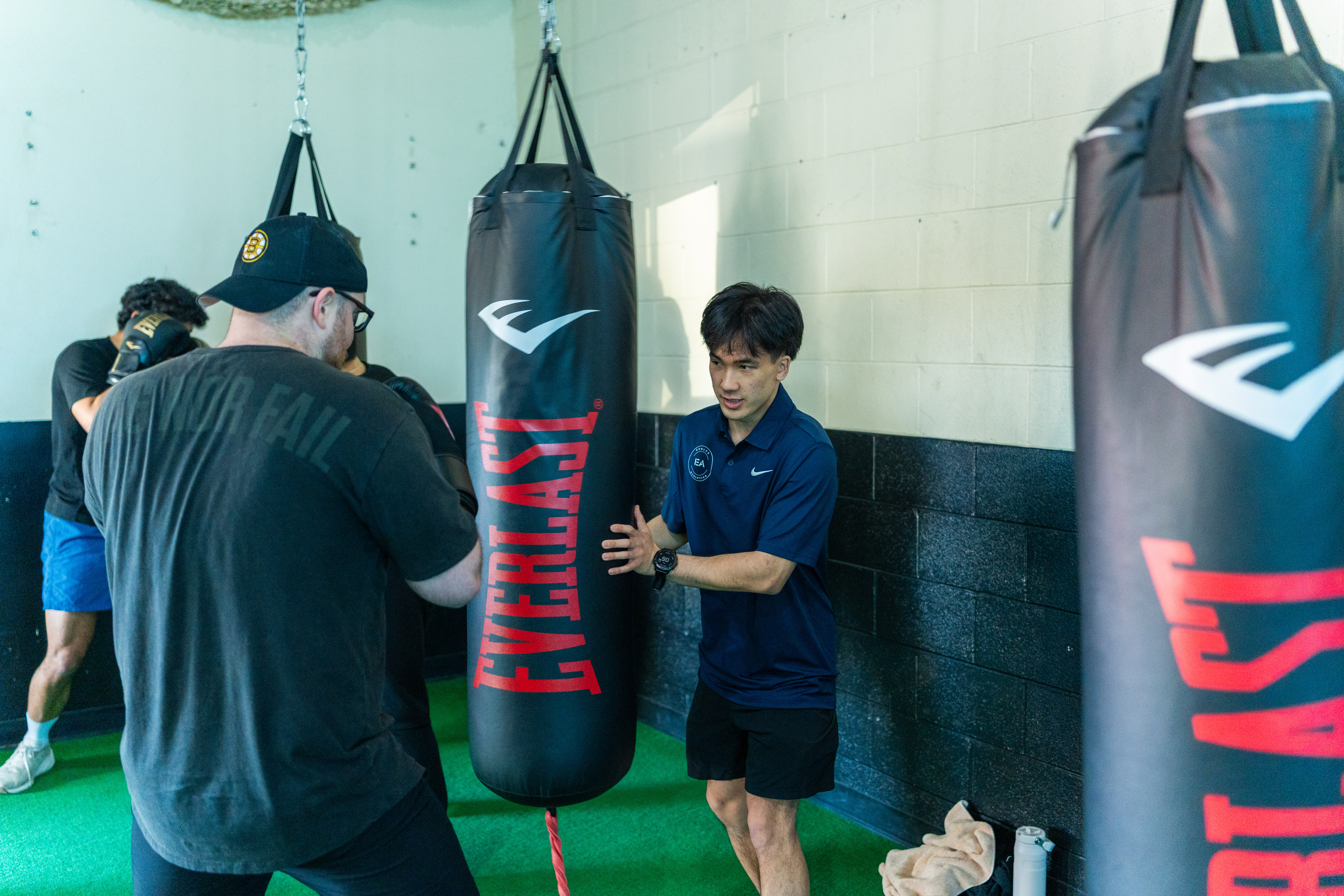 Noah coaching clients through bag work